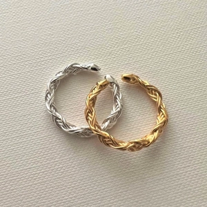 Close-up of gold and silver braided adjustable S925 sterling silver rings set