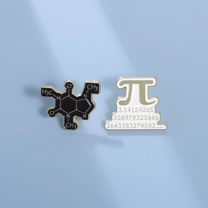 Creative Pi and caffeine molecule enamel pins with gold trim on light blue background
