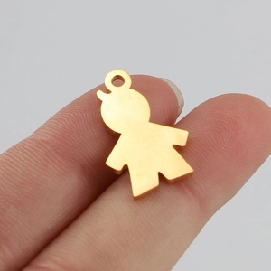 Detailed view of a gold stainless steel boy silhouette pendant held by fingers