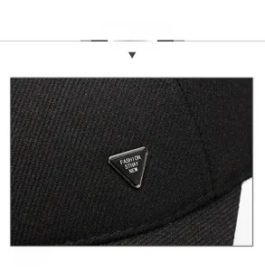 Detail view of premium black wool baseball cap with silver metal triangle fashion logo