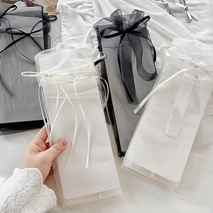 Transparent mesh sheer socks with glitter bow accents in classic black and white style