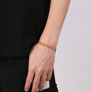 Close-up of minimalist gold link chain necklace on model featuring sleek round links