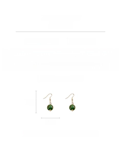 Detail view of retro green marble glass bead earrings with golden tassels on white background