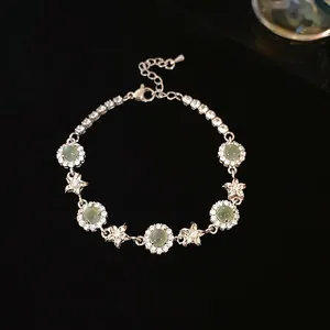 Exquisite zircon flower bracelet with pale green gemstones on black velvet background