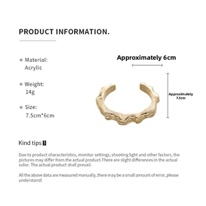 Detailed view of golden irregular geometric cuff bracelet showing 7.5cm by 6cm dimensions