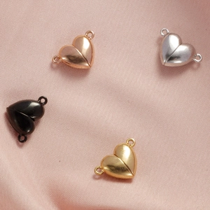 Magnetic heart clasps for bracelets in gold, silver, black and rose gold on pink silk