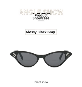 Close-up of black cat-eye glasses frame with silver stud accents and dark lenses