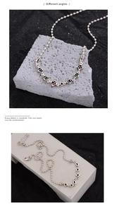 Macro detail of S925 sterling silver beaded chain with colorful zircon gemstone charms