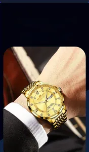 Detail of gold men's watch dial with Roman numerals and day-date display