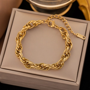 Close-up of golden interlocking rings on stainless steel bracelet with lobster clasp