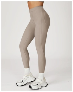 Detail view of high waisted yoga leggings in taupe with ergonomic side stitching
