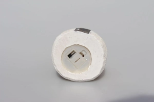Detail view of the LED light base showing the white resin texture and power switch