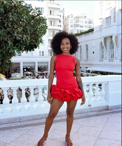 Detail of red sleeveless halter dress with layered ruffle hem and slim fit design