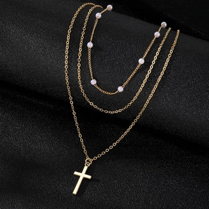 Three-layer gold necklace set with faux pearl accents and a sleek cross pendant