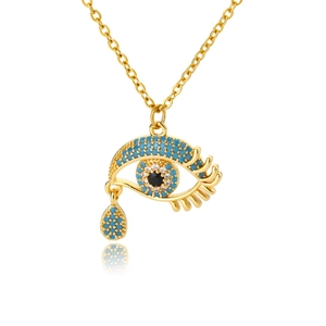 Macro detail of 18K gold plated evil eye pendant necklace with blue zircon and teardrop drop