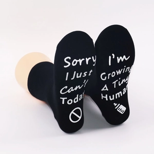 Black non-slip socks with Sorry I Just Can't and Growing A Tiny Human printed on soles