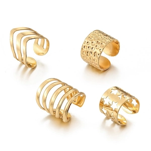 Set of four gold-tone metal ear cuffs with hollow star and textured multi-layer designs