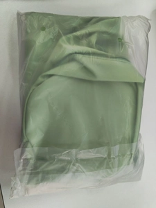 Folded green yoga bag packaged in a clear protective plastic bag for fitness travel