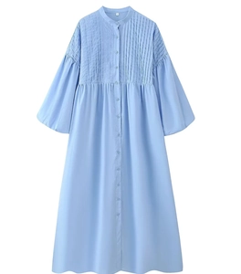 Close-up of light blue ramie dress featuring pintuck pleats and lantern sleeves