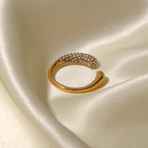 Close-up of gold stainless steel open ring with teardrop pave white zircons on silk