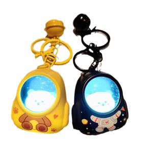 Luminous astronaut bear keychain for backpacks in yellow and black with LED light effect