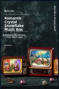 Detail of vintage TV music box with snow scene, warm lights and festive decor