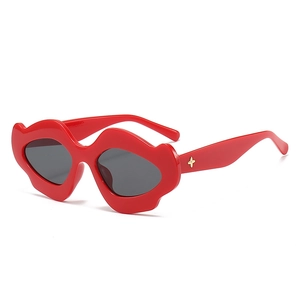 Punk style red lip-shaped sunglasses with dark grey lenses for festivals and outdoor travel