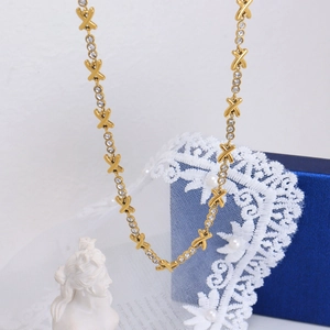 Luxurious gold-plated titanium X-shaped necklace with shimmering cubic zirconia accents