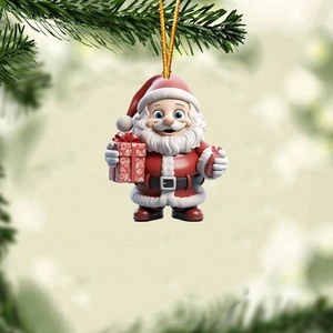 Close-up of Santa Claus ornament hanging on a Christmas tree branch with gold string