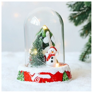 Detailed close-up of a lit Christmas glass dome featuring Santa Claus and LED warm lighting