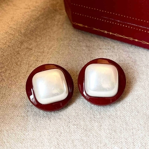 Macro shot of vintage style burgundy and pearly white resin square stud earring details