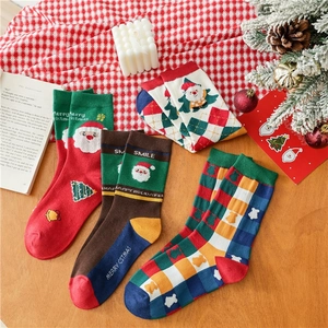 Detailed close-up of festive cotton Christmas socks with Santa Claus and holiday patterns