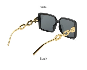 Detail view of square sunglasses featuring premium black frames and gold chain-link temples