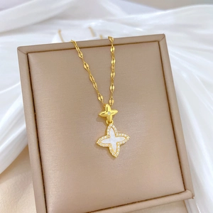 Detail of gold star pendant with white shell inlay and sparkling crystal border