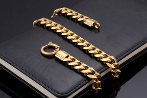 Close-up of gold-plated hip-hop cuban chains with diamond-encrusted clasps on black leather