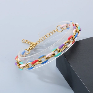 Detail of 18K gold Cuban link bracelet with colorful enamel inlay and lobster clasp