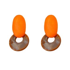 Minimalist resin wood earrings with orange oval stud and tortoise ring on white background