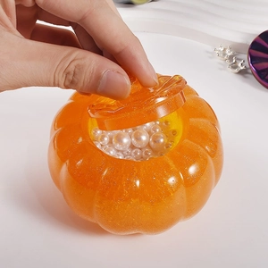 Detail of pumpkin-shaped resin storage box with sparkling finish and lid open