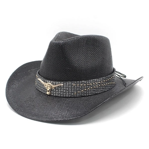 Black woven western cowboy hat with wide brim and golden bull head metal ornament