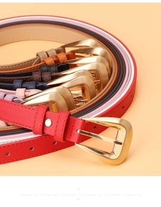 Detail of colorful PU leather belts for women with unique golden triangular metal buckles