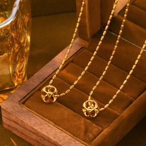 Elegant gold-plated beaded chain necklace with hollow heart cube pendant on wood box