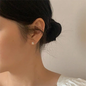 Minimalist 925 sterling silver stud earrings with zirconia on female model's ear