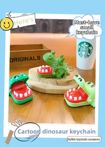 Detail showing three funny dinosaur teeth biting toy keychains on a wooden stand