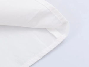 Detailed close-up of white poplin fabric texture and reinforced hem stitching on shirt