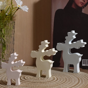 Three-piece abstract reindeer sculptures in matte white, cream, and pink for home decor