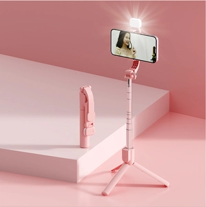 Pink foldable selfie stick with built-in tripod stand and detachable LED fill light detail