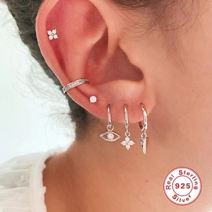 Close-up of S925 sterling silver earring set with zirconia on model's ear
