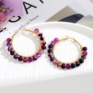 Detail of purple striped agate beads hand-wrapped on gold stainless steel hoop earrings