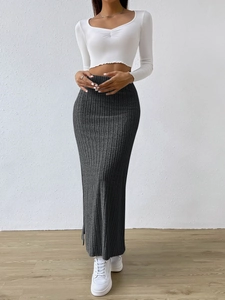 Detail shot of charcoal grey high-waist knit maxi skirt with elegant side slit design