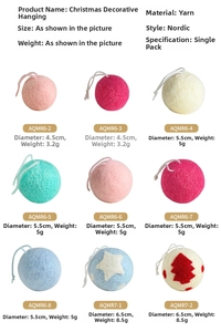 Detail view of wool felt Christmas ornaments in various sizes and festive patterns